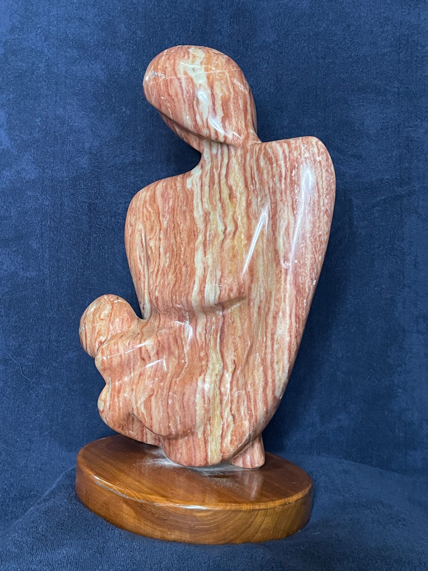 Cherish is carved from Utah red alabaster. Its smooth surface conveys a sense of tranquility and grace. represents the eternal bond of love between a mother and child. This is the first time a human being experiences love through the gentle touch of his/her mother. That is an everlasting love for both of them.
This sculpture was designed and carved by Shahla Rahimi Reynolds.
This piece is: 10" Width x 17 1/2" Height x 6 1/2" Depth.