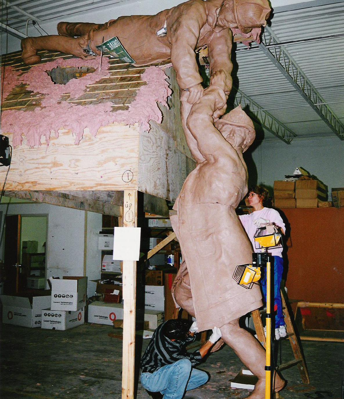 just_another_day.Sonarta.com Shahla created the 9 feet tall figures for Just Another Day Sculpture in clay before they were cast in bronze.