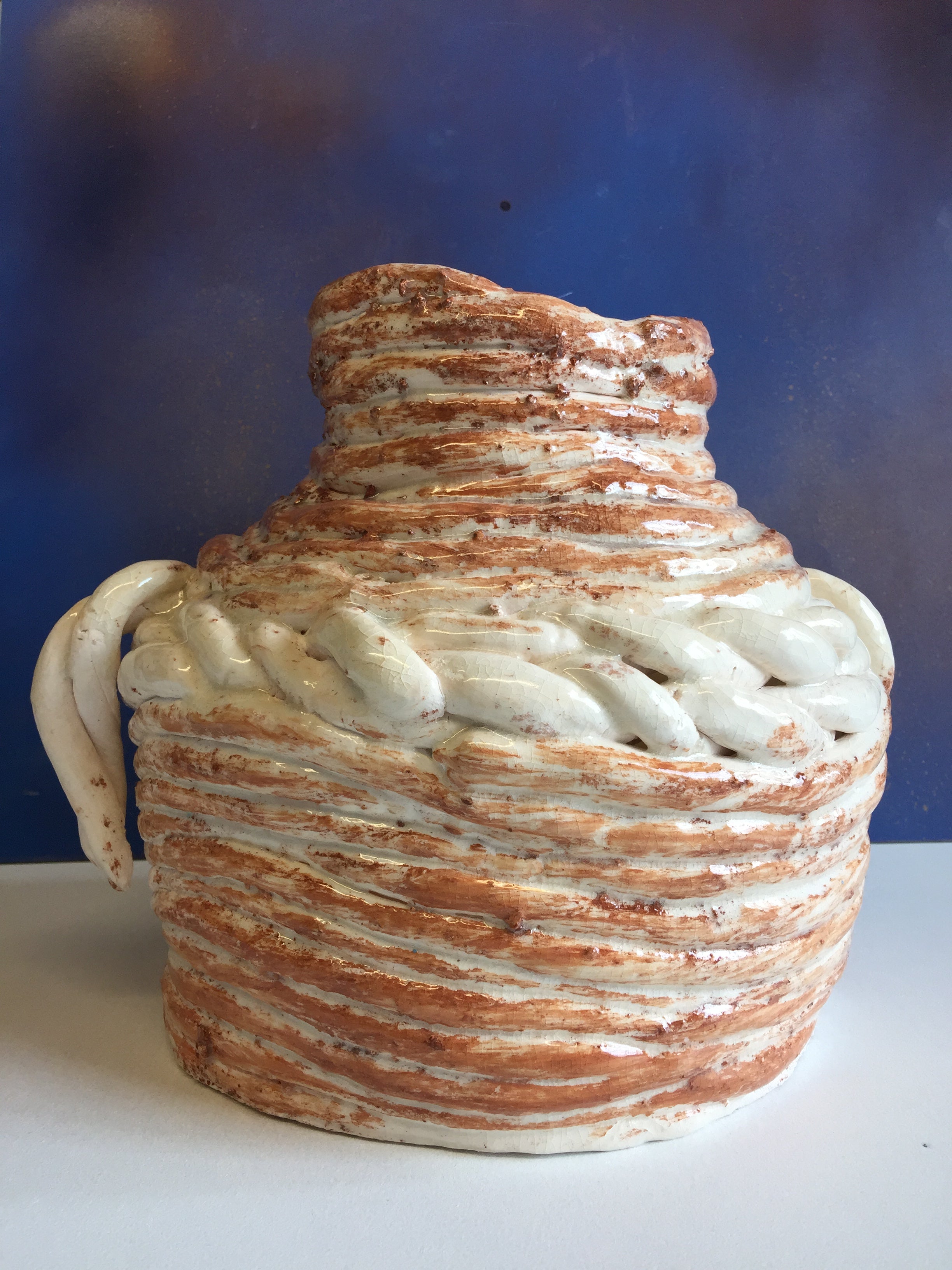 This is a Hand Built (Coil) Clay Pot. This piece copies the style of Greek and Roman pottery, which was used in ancient times to keep liquids cool. The Earthy Earthen Wear I was created by Shahla rahimi Reynolds. It is 11" H x 10" W.